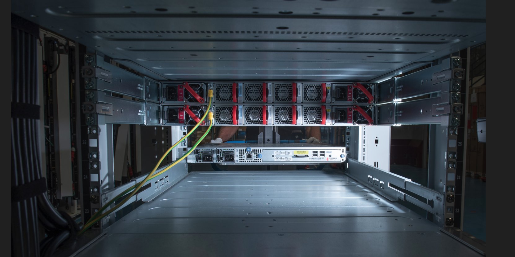 Inside a rack during integration: power supplies and a server being fitted