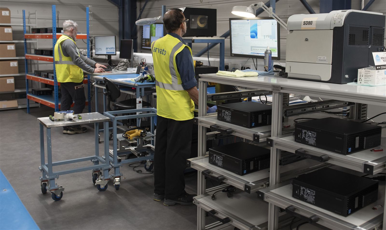 Arvato technicians at integration workbenches in the Swords facility